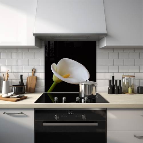 Close-up of a white calla lily on a black background.