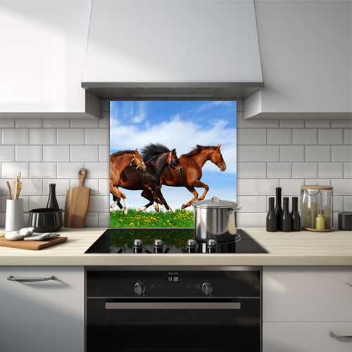 Three horses racing on green grass glass splashback.