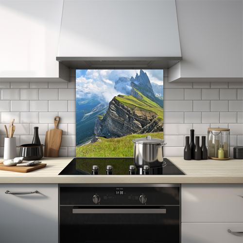 Rocky outcrop with misty clouds and grassy foreground glass splashback.