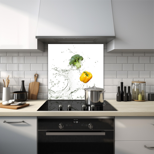 Broccoli and yellow pepper with water splashes glass splashback.