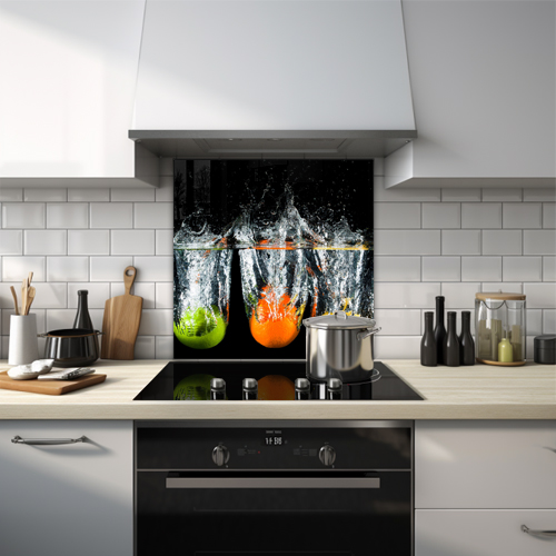 Fruits being dropped into water glass splashback.