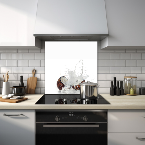Coconut juice splash from a cut coconut glass splashback.
