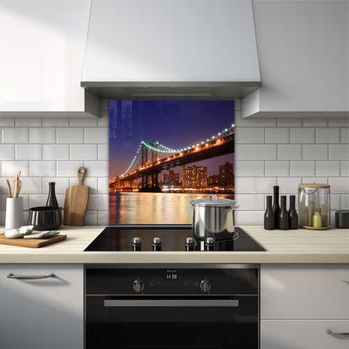 Manhattan bridge lit up in green and orange at night glass splashback.