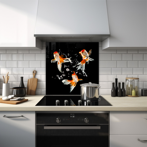 Three goldfish with bubbles on a black background glass splashback.