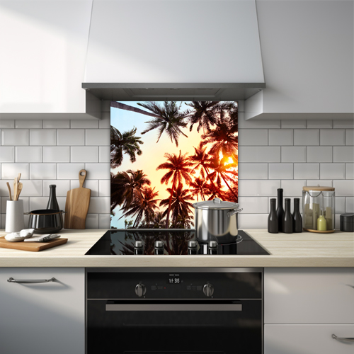 Tropical trees viewed from bottom up with sunset glass splashback.