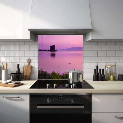 Glass splashback of Castle Stalker during sunrise with a purple sky.