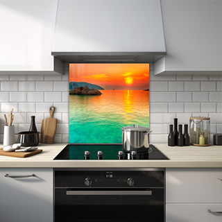 Sunset over turquoise water with rock and mountain glass splashback. thumbnail