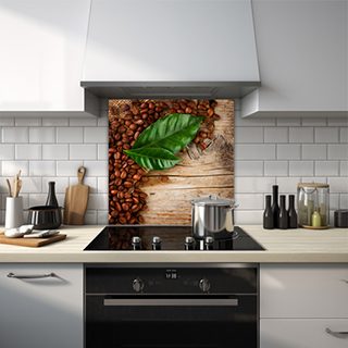 Glass splashback of coffee beans and leaves on a wooden oak table. thumbnail